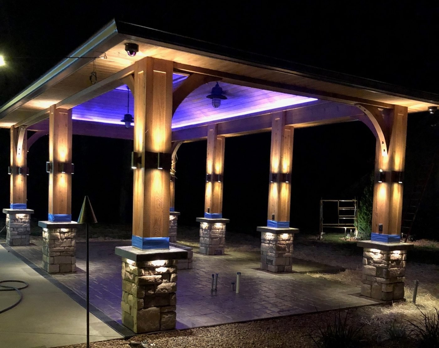 Outdoor pavilion with white column lights and a purple accent ceiling